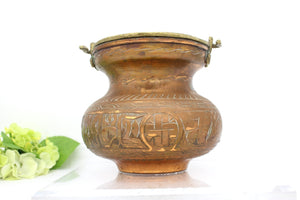 Old copper pot with handle,
