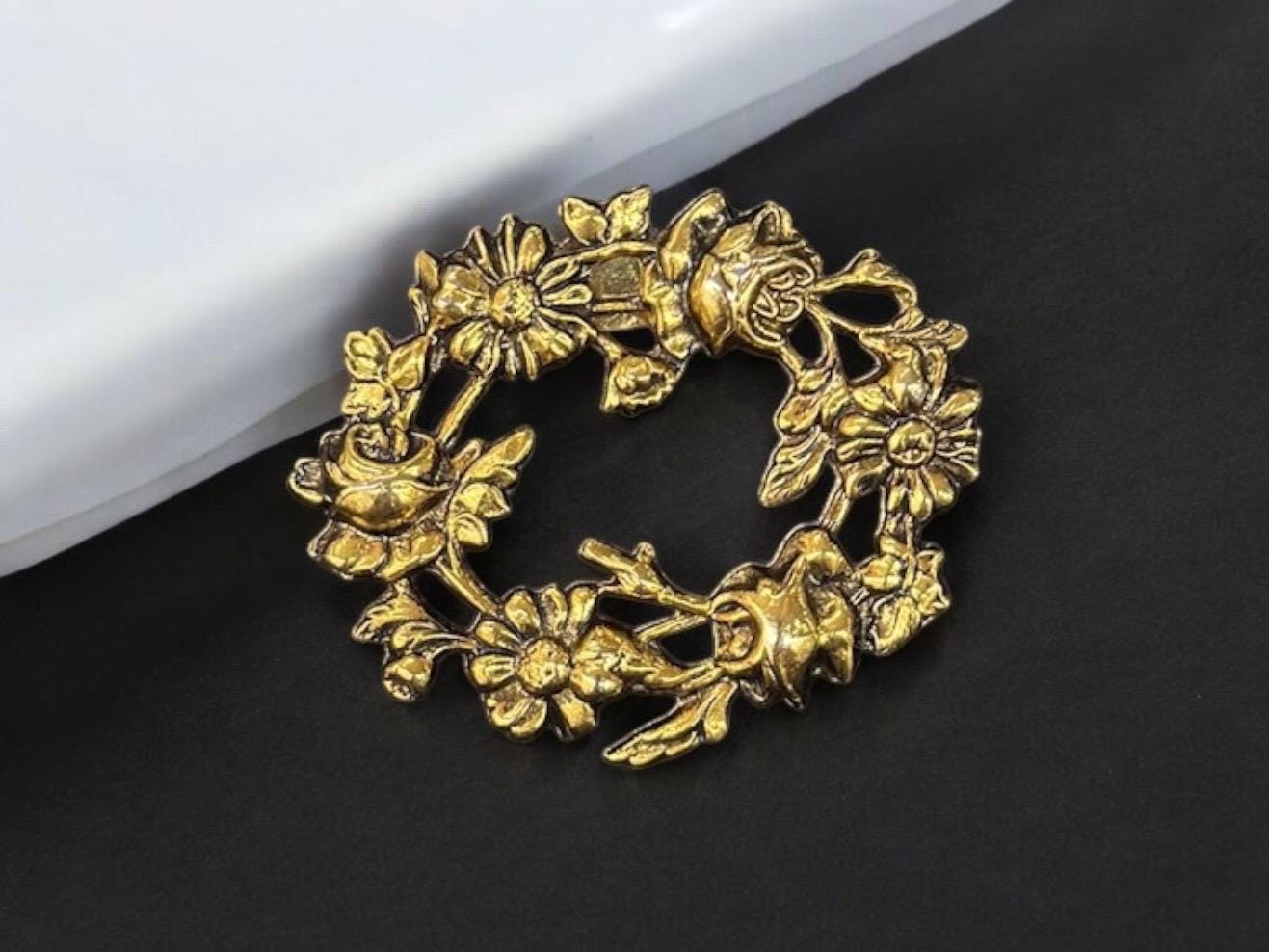 gold color metal flower brooch