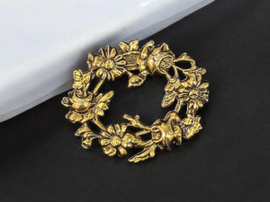 gold color metal flower brooch