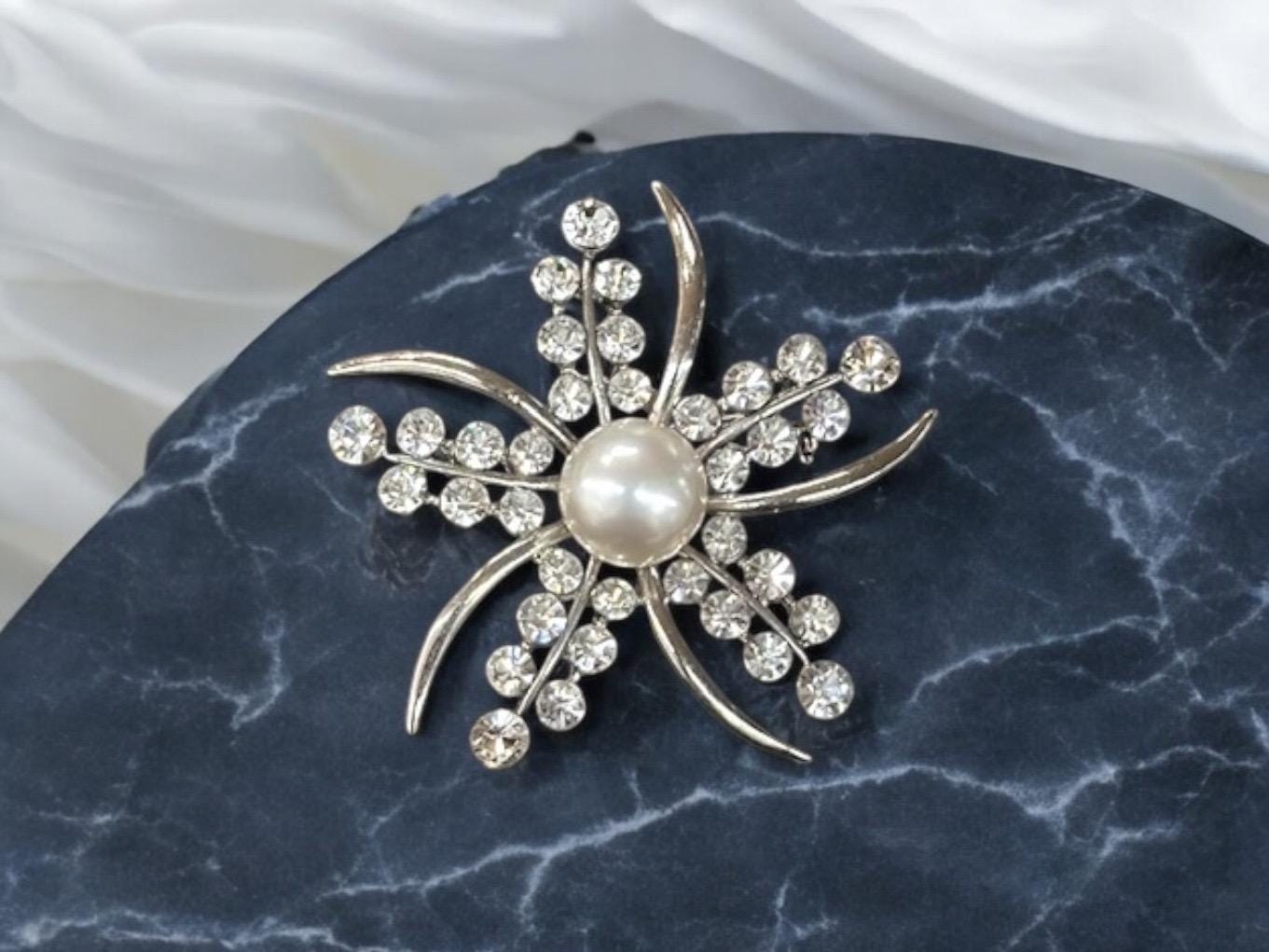 faux pearl and rhinestone brooch